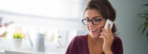 Woman on phone contacting her local dentist's office