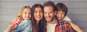 Smiling family of four posing for a photo