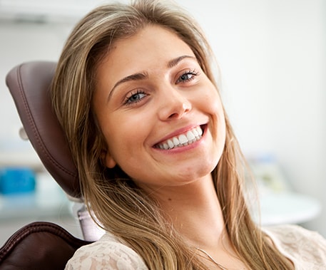 smiling young woman in a dental chair