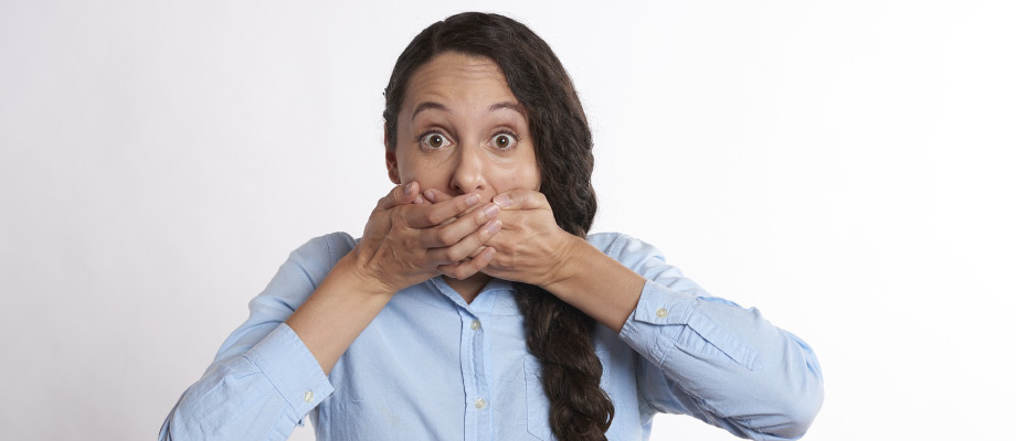 woman covering up her yellow teeth